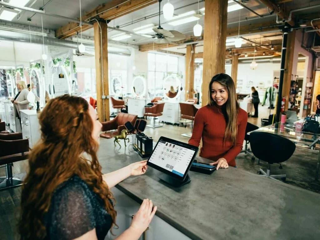 A customer and a shop owner making a transaction.