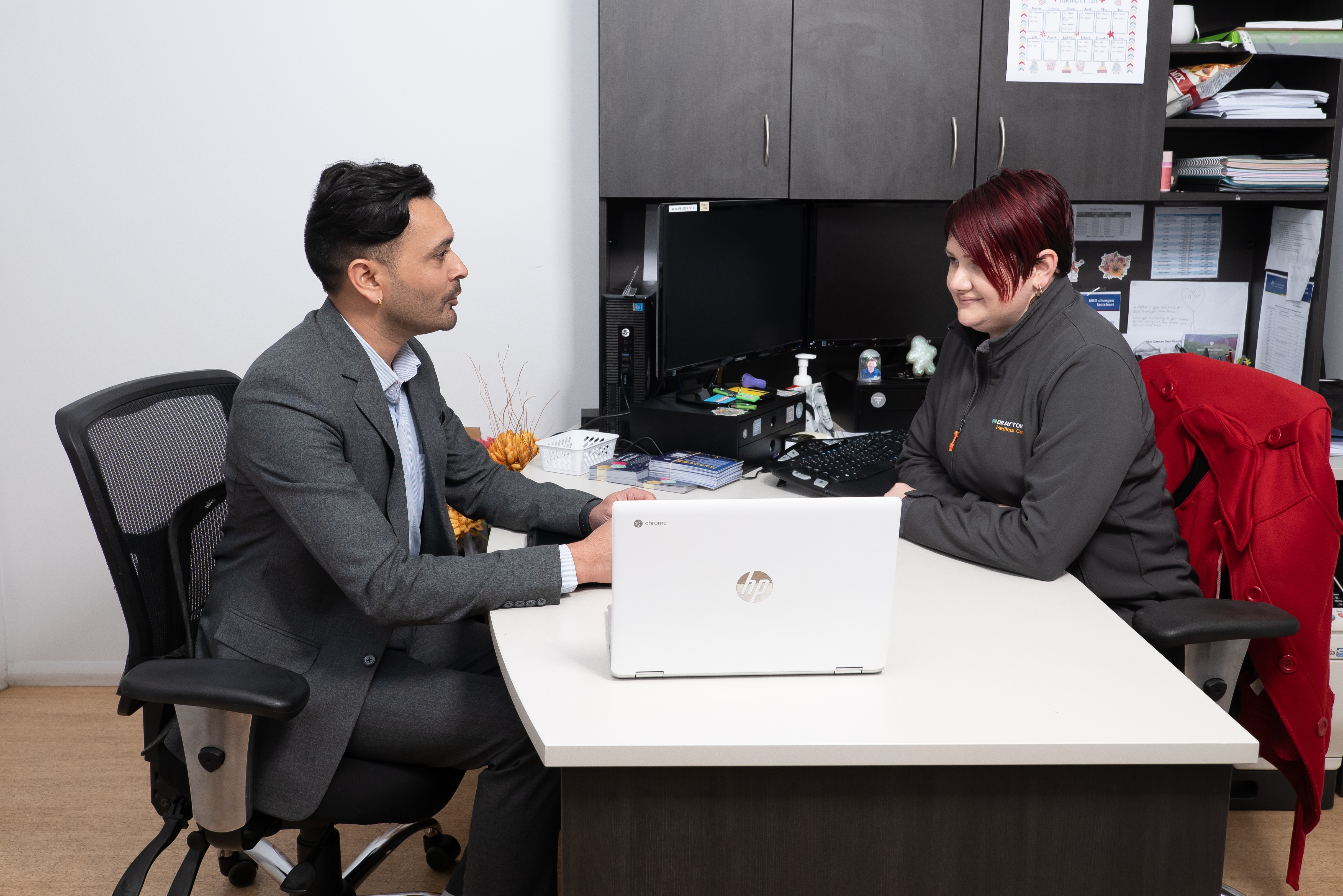 The GRIVITY team discussing digital marketing results with a client in a professional setting.